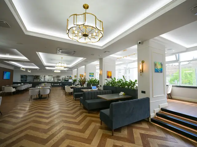 Зал с панорамными окнами и зелёными зонами